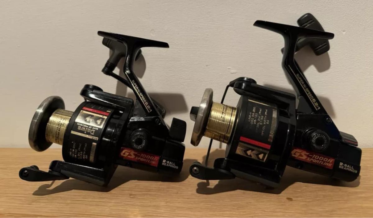 Two spinning reels of different sizes placed side by side.